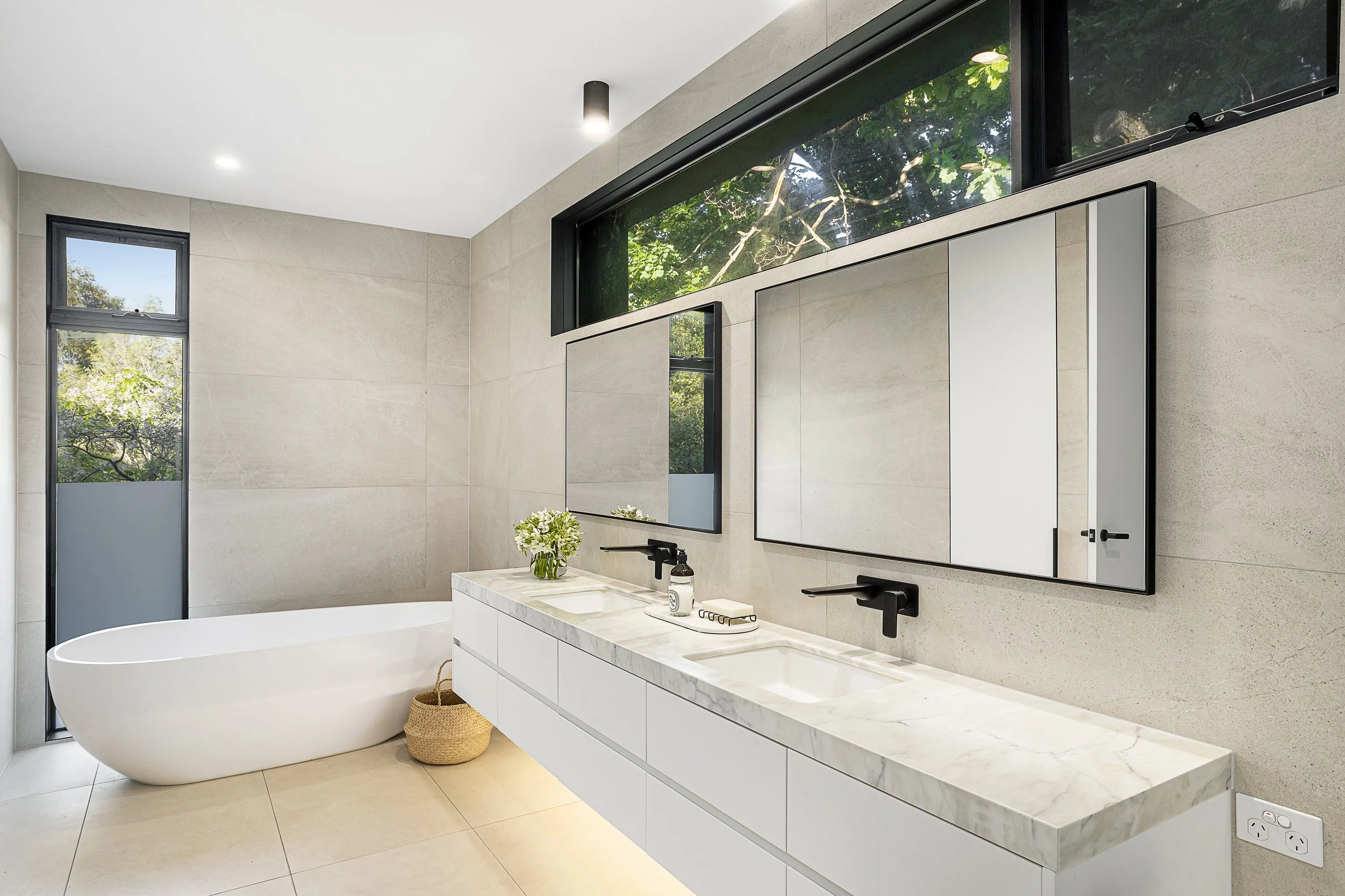 Bathroom with floor-to-ceiling tiling and stone vanity